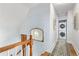 Hallway with stacked washer and dryer and view of stairs and unique wallpaper at 858 S Emerson St, Denver, CO 80209