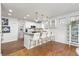 Open kitchen features island seating, stainless appliances, granite countertops, and views into the dining area at 858 S Emerson St, Denver, CO 80209