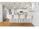 Spacious kitchen with island seating, granite countertops, stainless steel appliances, and stylish pendant lighting at 858 S Emerson St, Denver, CO 80209