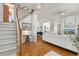 Open-concept living room with hardwood floors, staircase and dining room views at 858 S Emerson St, Denver, CO 80209