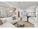 Open-concept living room featuring a seating area and staircase with dining room view at 858 S Emerson St, Denver, CO 80209