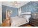 Stylish main bedroom featuring patterned wallpaper, hardwood floors, and ample natural light at 858 S Emerson St, Denver, CO 80209