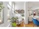 Bright sun room with a sitting area, large windows, and unique decorative plant shelves at 858 S Emerson St, Denver, CO 80209