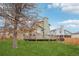 Well-maintained backyard featuring a deck, lawn, and mature trees and fencing at 12690 W Brandt Dr, Littleton, CO 80127