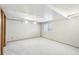 Finished basement featuring carpet floors, a drop ceiling, and natural light at 12690 W Brandt Dr, Littleton, CO 80127