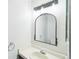 Bathroom with a mirror, white vanity, and fixtures at 12690 W Brandt Dr, Littleton, CO 80127