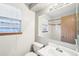Bathroom with a mirror, toilet, sink, and window at 12690 W Brandt Dr, Littleton, CO 80127