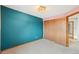 Carpeted bedroom featuring teal and pink walls with a window at 12690 W Brandt Dr, Littleton, CO 80127