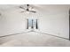 Spacious bedroom with neutral carpet, walls, and a large window at 12690 W Brandt Dr, Littleton, CO 80127