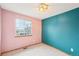 Carpeted bedroom features pink and teal walls, a standard window, and ceiling lighting at 12690 W Brandt Dr, Littleton, CO 80127