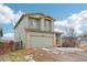 Two-story home with an attached garage, brick accents and neutral paint against a blue sky at 12690 W Brandt Dr, Littleton, CO 80127