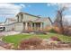 Inviting home with a well-maintained lawn, mature landscaping, and a cozy front porch at 12690 W Brandt Dr, Littleton, CO 80127