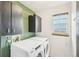 Laundry room with modern washer and dryer and ample storage at 12690 W Brandt Dr, Littleton, CO 80127