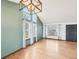 A well-lit living room with high ceilings, hardwood floors, and modern lighting at 12690 W Brandt Dr, Littleton, CO 80127