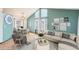 A bright living room with high ceilings, a dining area, and modern decor at 12690 W Brandt Dr, Littleton, CO 80127