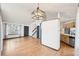 Open floor plan with hardwood floors, modern lighting, and access to kitchen at 12690 W Brandt Dr, Littleton, CO 80127