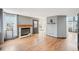 A living room featuring a brick fireplace, wood floors, and ample natural light at 12690 W Brandt Dr, Littleton, CO 80127