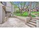 Backyard area featuring concrete patio, tiered landscaping, and steps leading to upper yard at 275 Pearl St # 11, Boulder, CO 80302