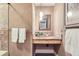 Elegant bathroom featuring a rustic countertop, stylish mirror, modern lighting, and decorative tiles at 275 Pearl St # 11, Boulder, CO 80302