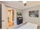 Comfortable bedroom with a dresser, painting and open door showing the hardwood floors throughout the home at 275 Pearl St # 11, Boulder, CO 80302