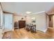 Cozy dining area with hardwood floors, a modern table, and a decorative cabinet at 275 Pearl St # 11, Boulder, CO 80302