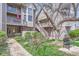 Charming multi-level condo featuring balconies, red accents, and landscaped surroundings at 275 Pearl St # 11, Boulder, CO 80302