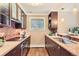 Well-equipped kitchen with dark cabinets, modern appliances, tile backsplash, and ample counter space at 275 Pearl St # 11, Boulder, CO 80302