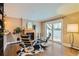 Bright living room boasting a fireplace, hardwood floors, and sliding glass doors to private balcony at 275 Pearl St # 11, Boulder, CO 80302