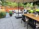 Backyard patio featuring a dining table, seating area, and a lush, green garden at 4074 S Poplar Way, Denver, CO 80237