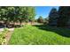 Lush backyard featuring mature trees, manicured lawn, and inviting outdoor space for entertaining at 4074 S Poplar Way, Denver, CO 80237
