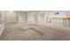 Spacious basement featuring neutral carpet, white walls, and a wet bar at 4074 S Poplar Way, Denver, CO 80237