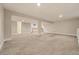 An expansive basement has plush carpeting, recessed lighting, and a partial kitchen area at 4074 S Poplar Way, Denver, CO 80237