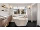 Elegant bathroom featuring a standalone tub, stylish lighting, and contemporary design for a relaxing oasis at 4074 S Poplar Way, Denver, CO 80237