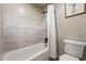 This bathroom features a tub with a shower, accented by modern tile and fixtures at 4074 S Poplar Way, Denver, CO 80237