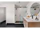 Modern bathroom with glass-enclosed shower, sleek vanity, and contemporary fixtures for a clean and stylish design at 4074 S Poplar Way, Denver, CO 80237