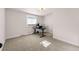 Bright bedroom with neutral carpet, large window, and space for a home office at 4074 S Poplar Way, Denver, CO 80237
