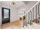 Inviting entryway with hardwood floors, staircase, and contemporary light fixture at 4074 S Poplar Way, Denver, CO 80237
