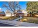 Charming two-story home with a well-manicured front yard and inviting walkway at 4074 S Poplar Way, Denver, CO 80237
