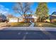 Charming two-story home with landscaped front yard, brick accents, and attached garage at 4074 S Poplar Way, Denver, CO 80237