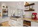 Gourmet kitchen with professional-grade gas range, granite countertops, and custom cabinetry at 4074 S Poplar Way, Denver, CO 80237