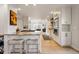 Open-concept kitchen with granite countertops, an island with bar stools, and stainless steel appliances at 4074 S Poplar Way, Denver, CO 80237