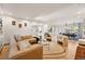 Open-concept living room with hardwood floors, a brick fireplace, and stylish furniture at 4074 S Poplar Way, Denver, CO 80237