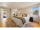 Cozy main bedroom featuring a plush bed, large window, and hardwood floors for a relaxing retreat at 4074 S Poplar Way, Denver, CO 80237