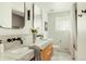 Contemporary bathroom featuring double sinks, marble countertops, and modern fixtures at 2060 Kline St, Lakewood, CO 80215