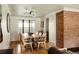Elegant dining room with modern lighting, hardwood floors, and a view into the living room at 2060 Kline St, Lakewood, CO 80215