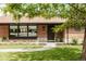 Charming brick home featuring a professionally landscaped yard and inviting front entrance at 2060 Kline St, Lakewood, CO 80215