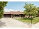 Attractive brick home with a well-manicured lawn, long driveway, and attached garage at 2060 Kline St, Lakewood, CO 80215