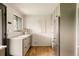 Bright kitchen featuring modern appliances, plenty of storage, and hardwood floors at 2060 Kline St, Lakewood, CO 80215