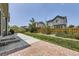 Fenced backyard includes a brick patio area and green lawn at 12993 E 108Th Ave, Commerce City, CO 80022