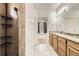 Bright bathroom with double sink vanity, tile shower, and tile floors at 12993 E 108Th Ave, Commerce City, CO 80022